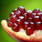 A cut-open section of a pomegranate, displaying the seeds.