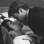 Two men kissing